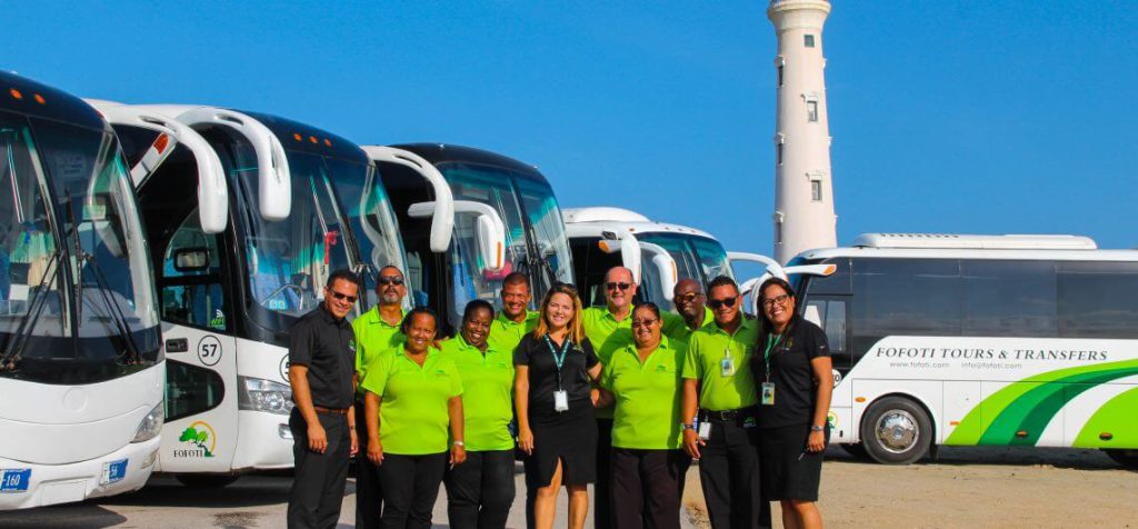 a group of people standing in front of a bus
